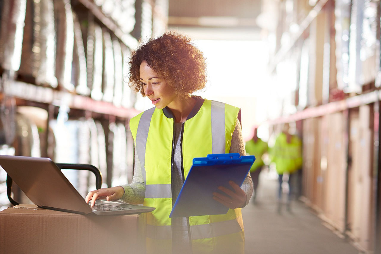 Female in warehouse working with technology solutions