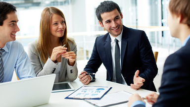 Business professionals in conference room talking