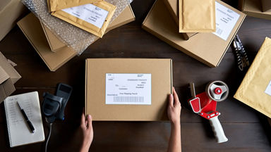 Birds eye view of a package on a table surrounded by other packing tools