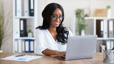 Female using her laptop in a home office 