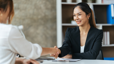 Two women shaking hands 