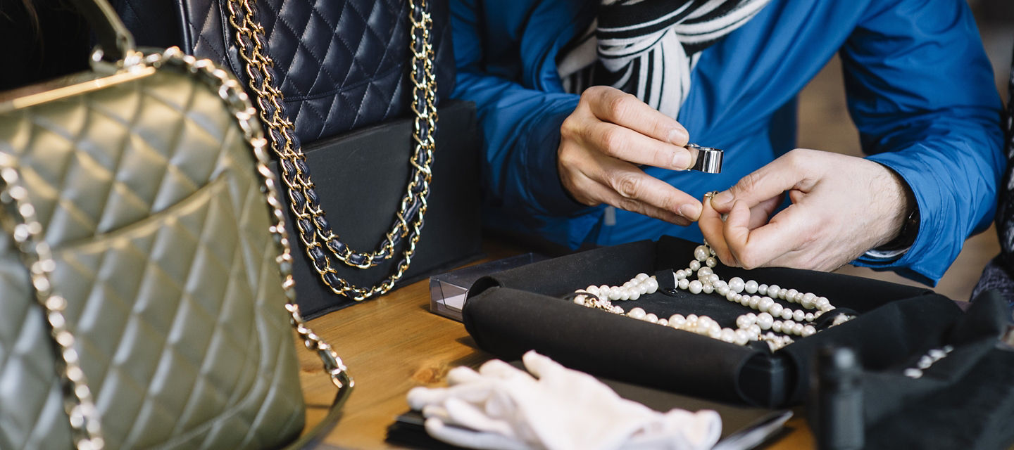 Person looking at gem with loop